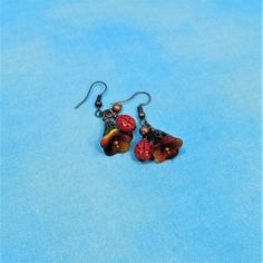 Two small Czech glass ladybugs are combined with Czech glass flowers, and dangle 1 inch from nickel free ear wires. They would be a fun gift idea for a special lady in your life.  These earrings are handmade and ready to ship via USPS to your US location at no extra cost. (International shipping also available. Please be aware of your local laws related to customs and VAT.) INTERNATIONAL CUSTOMERS: Some countries charge additional fees for customs and other taxes that cannot be calculated and collected in advance. These will be charged upon entry into your country. Please be aware of the laws of your country and the additional fees that might be levied related to your purchase. Adjustable Dangle Earrings With Flower Charm, Whimsical Dangle Flower Earrings, Whimsical Adjustable Flower Charm Earrings, Dangle Flower Earrings As Gift, Nickel Free Dangle Flower Earrings For Gifts, Nickel-free Czech Glass Flower Earrings, Dangle Flower Earrings With Ear Wire As A Gift, Whimsical Flower Charm Earrings For Gift, Czech Glass Flower Earrings For Gifting