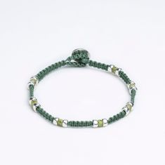 a green beaded bracelet with silver beads