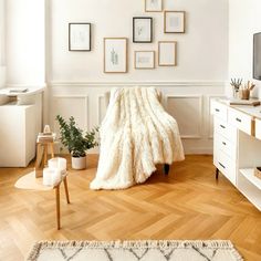 a living room filled with furniture and pictures on the wall