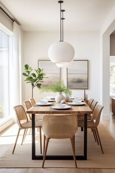 a dining room table with chairs and plates on it