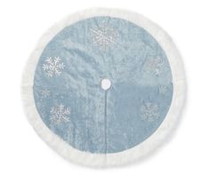 a blue and white round rug with snowflakes on the top, in front of a white background