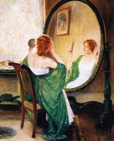 a woman sitting at a table in front of a mirror