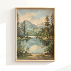 a painting hanging on the wall above a lake