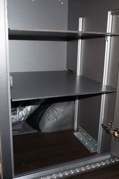 an empty shelf in the corner of a room that is being renovated with metal studs