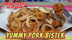 a white plate topped with meat and onions on top of a colorful table cloth next to a fork