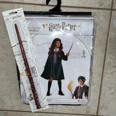 a harry potter costume and wand are on display