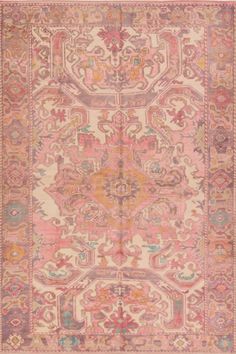 an antique rug with pink and orange colors