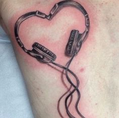 a heart shaped tattoo with headphones attached to it