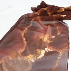 The colors in this light weight silk scarf are so striking! Ranging from a deep rust to fushia, orange, brown and tan - and everything in between, this scarf really is one of a kind! Dyed first with metal and then painted in layers to create depth, this scarf is a work of art! Measuring approximately 14" x 72" Dry Clean Only Silk Chiffon Scarves, Hand Dyed Silk, Chiffon Scarf, Silk Dyeing, Orange Brown, Silk Chiffon, Beautiful Hand, Silk Scarf, Wearable Art