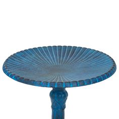 a blue glass plate sitting on top of a table