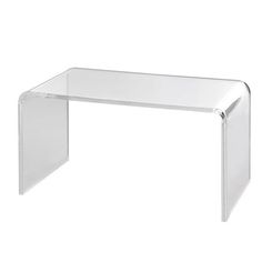 an acrylic table with clear legs on a white background