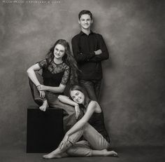 three people posing for a black and white photo