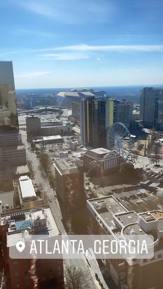 an aerial view of the city with tall buildings and ferris wheel in the distance, atlanta, georgia