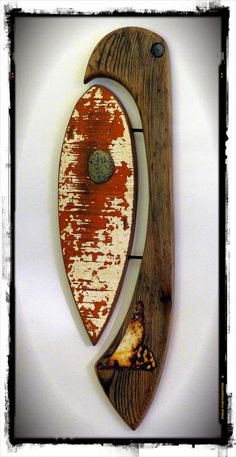 a wooden surfboard mounted to the side of a wall