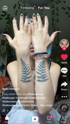 a woman with tattoos on her arms and hands