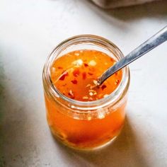 a spoon in a jar filled with liquid