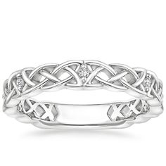 a white gold wedding band with diamonds in the center and an intertwined design on each side