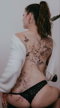 a woman with tattoos on her back