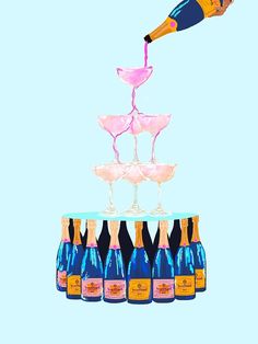 a person pouring wine into several glasses on top of a cake with pink and blue frosting