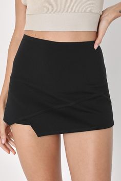 Shake it like you mean it in the Lulus Groove Queen Black Skort! A pair of high-waisted shorts (made from super stretchy knit) is topped with a cute skort panel in the front that falls to an edgy, asymmetrical hemline. Hidden back zipper. Fit: This garment fits true to size. Length: Above mid-thigh. Size medium measures 14.5" from waist to hem. Inseam: 2.00 Front Rise: 6.00 Waist: Fitted - very fitted at natural waist. Hip: Loosely Fitted. Fabric: Fabric has some stretch. Lined. Shell: 65% Rayon Short Skort With Built-in Shorts For Night Out, Trendy Stretch Mini Skirt With Built-in Shorts, Trendy Mini Skort With Built-in Shorts, Stretch Mini Shorts For Night Out, Trendy Black Mini Skirt With Built-in Shorts, Trendy Stretch Skort With Short Inseam, Solid Elastane Mini Skirt With Built-in Shorts, Trendy Mini Length Elastane Skort, Chic High Waist Elastane Shorts