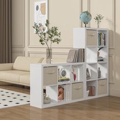 a living room filled with furniture and a white book shelf on top of a hard wood floor