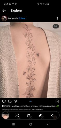 the back of a woman's neck is shown with flowers and leaves on it