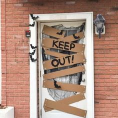 a door that has been decorated with cardboard taped to it and the words keep out