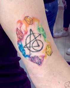 a person with a tattoo on their arm that has an image of the symbol in it