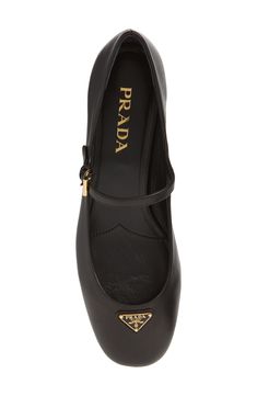 Prada's iconic triangle logo highlights the rounded toe of this mary jane–style pump crafted of smooth lambskin leather and set on a low block heel. 1 1/2" (38mm) heel (size 38.5) Adjustable strap with buckle closure Leather upper, lining and sole Made in Italy Designer Shoes Prada School Shoes, Prada Shoes Women, Prada Mary Jane, Prada 2015, 60s Clothing, Black School Shoes, Prada Pumps, Prada Heels, Shoes Prada