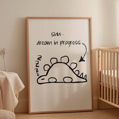 a drawing on the wall next to a crib with a baby's bed in it