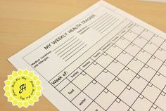 a close up of a piece of paper on a wooden table with a yellow seal