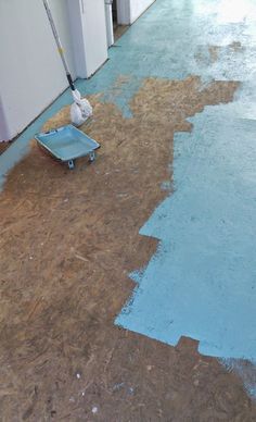 the floor is being painted with blue paint