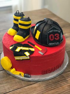 a birthday cake with fireman's gear on top