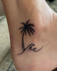 a small palm tree and wave tattoo on the foot