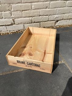 a wooden crate sitting in front of a brick wall