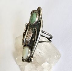 "an amazing and amazingly tall southwestern ring, artisan-made. top stone looks like a green turquoise, bottom one is a mother-of-pearl. beautiful feather and details, nice condition. marked with a stamping on the back. has a fair amount of patina but not much in the way of wear. mother-of-pearl shows some surface wear. size: 5.75 height of face: 1 and 15/16\" width of face: a bit over 13/16\" width of inner band: a bit over 1/16\"" Gold Diamond Band, Vintage Turquoise, Pinky Ring, Green Turquoise, Green Stone, Perfect Ring, Diamond Bands, Turquoise Ring, Mother Of Pearl