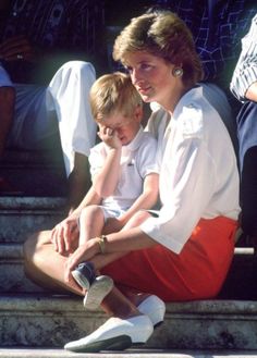 a woman sitting on the steps with a child