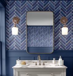 a bathroom with blue and white tiles on the wall, two sinks and a large mirror