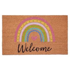 a welcome mat with a rainbow and the word welcome on it in black lettering that reads,