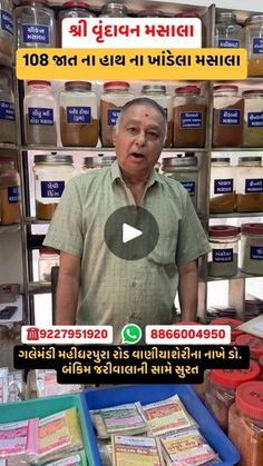 a man is standing in front of some jars with food items on display behind him