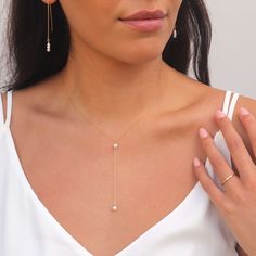 pearl lariat necklace in gold filled on model posing with hand Bridal Jewelry V Neck Dress, Jewelry Bride Wedding, Pearl Necklace Prom, Pearl Bridal Necklace, Pearl Necklace Wedding The Bride, Dainty Pearl Wedding Jewelry, Bachelorette Jewelry, Wedding Jewelry Pearls, Simple Bridesmaid Jewelry