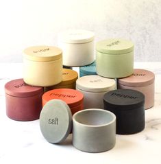 many different colored containers sitting on top of a table