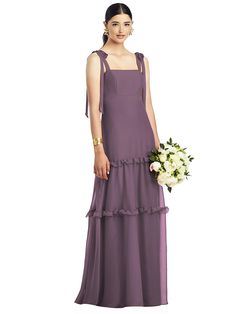 a woman in a long purple dress holding a bouquet