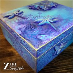 a blue and purple box sitting on top of a wooden table