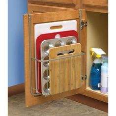 the kitchen cabinet door is open to show dishes and utensils in its holder