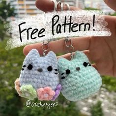 two small crocheted cats hanging from a keychain that says free pattern