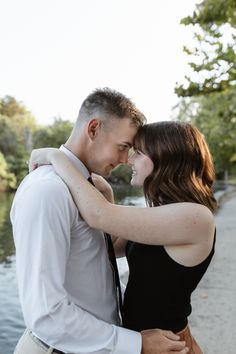 a man and woman embracing each other by the water