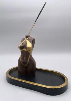 a figurine with a stick in it's mouth sitting on a tray