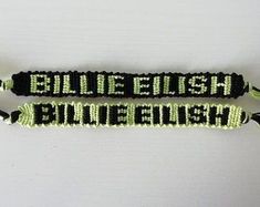 two black and green beaded bracelets with the words'bliee english'on them