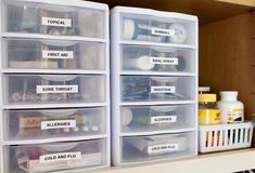 several plastic containers with labels on them are sitting on a shelf next to other items